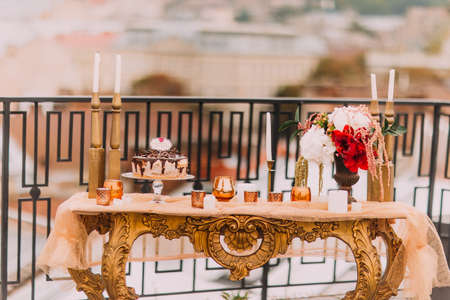 Golden wedding table in oriental style with cake and snacks. Wedding decorations close up.の写真素材