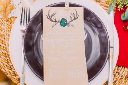 Cute wedding postcard on the plate close up.の写真素材