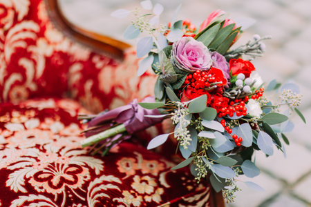 Stylish wedding bouquet on the vintage red armchair close upLの写真素材