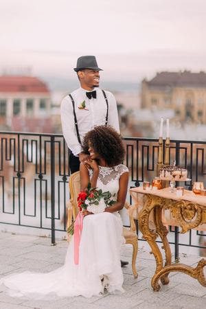 Happy african newlyweds smiling on the terrace.の写真素材