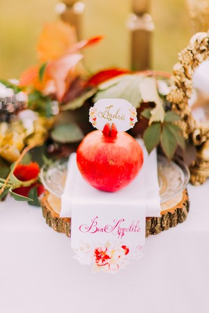 Sweet red pomegranate on the wedding table close up.の写真素材