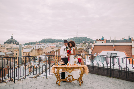 Happy african wedding couple posing for camera on the terrace.の写真素材
