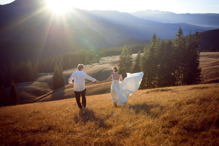 Wedding couple having fun in the mountains. Honeymoon.の写真素材
