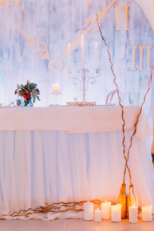 Creative wedding table with cake and candles.の写真素材