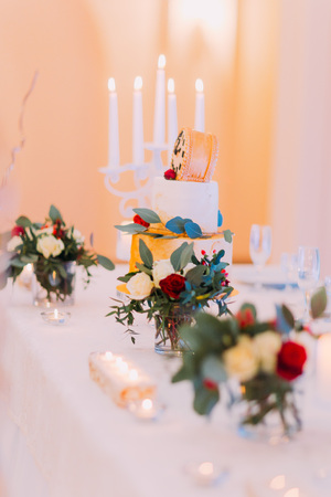 Beautiful wedding table decorated with candles and flowers.の写真素材