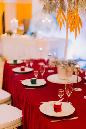 Luxurious wedding table with red tablecloth.  Wedding celebration.の写真素材