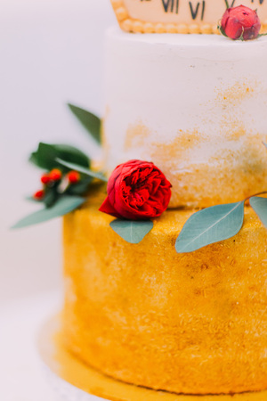 Wedding cake decorated with clocks and flowers close up.の写真素材