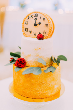 Wedding cake decorated with clocks and flowers close up.の写真素材