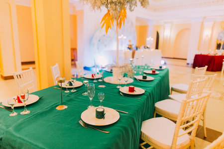 Wedding table with green tablecloth. Wedding celebration in luxurious restaurantの写真素材