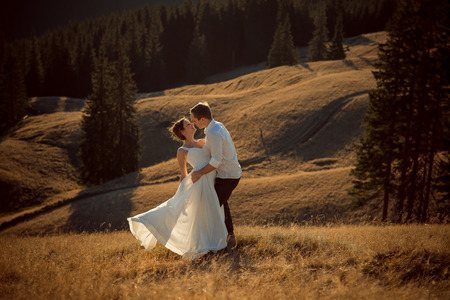 Lovely wedding couple kissing. Beautiful mountain landscape on background.の写真素材