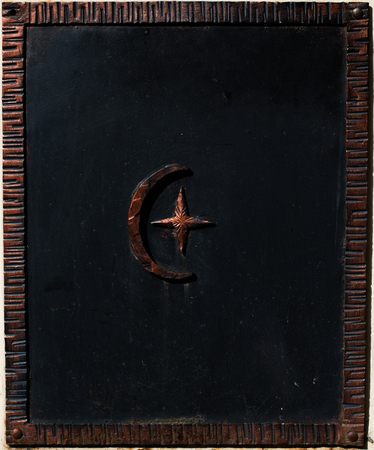 Forged muslim symbol on the old wall close up.の写真素材