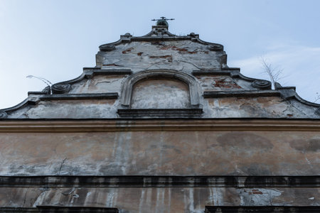 Old facade of the Roman Catholic Church on clear sky background.