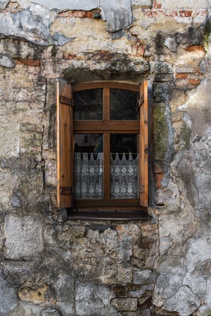 Vintage window with wooden shutters on the stoned house.の写真素材
