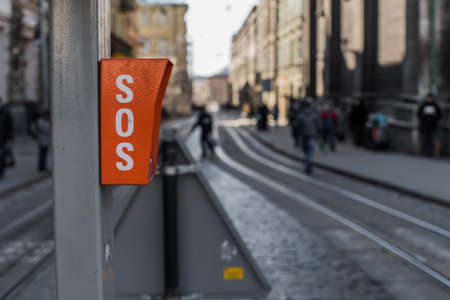 Sign SOS on the pole. Road traffic background.