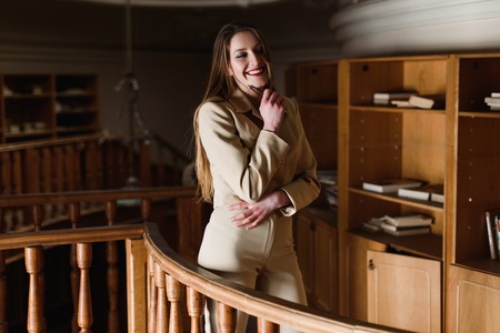Beautiful young stylish lady posing in the vintage library.の写真素材