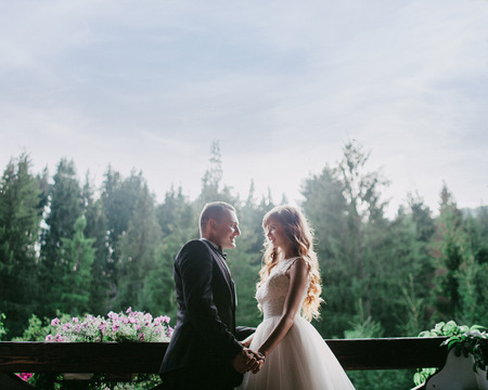 Bride and Groom at wedding Day walking Outdoors on nature. Bridal couple, Happy Newlywed woman and man embracing. Loving wedding couple outdoor.の写真素材