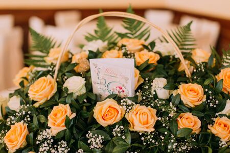 Bouquet of beautiful roses with postcard on a white wooden table. Wedding day.の写真素材