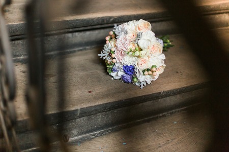 Vintage photo of pink wedding bouquet on the stairsの写真素材