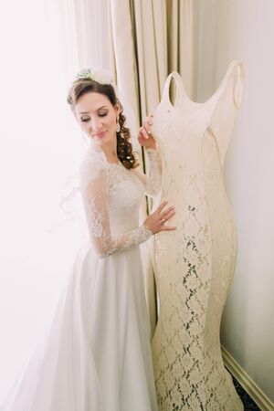 Portrait of young smiling brunette  bride in hotel roomの写真素材