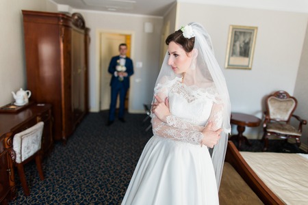stylish luxury bride and handsome elegant groom posing on the background of rich interior in old building.の写真素材