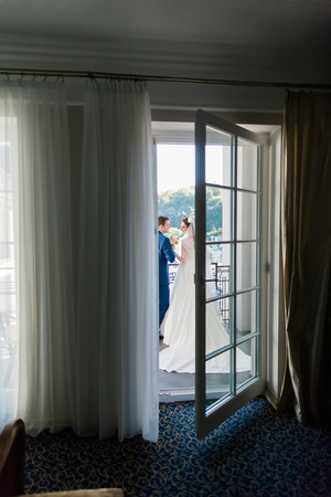 the bride and groom on the balcony in the hotel room.の写真素材