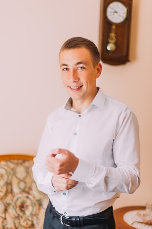 Close up of businessman wearing cufflinks. Elegant young fashion business manの写真素材