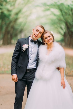 Luxury married wedding couple, bride and groom posing in park autumnの写真素材