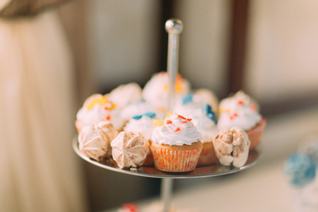 Cute cupcakes on tier at wedding reception.の写真素材
