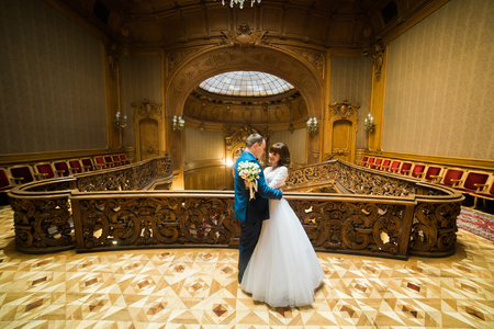 Elegant wedding couple dancing at vintage house in the front of old stained-glass ceiling.の写真素材