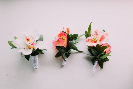 Group of Lily wedding boutonnieres on white background.の写真素材
