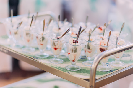 Delicious ice cream in glass bowls on sweet dessert wedding table.の写真素材