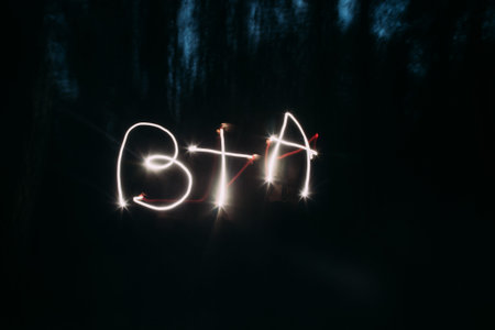 Light painting of initials on night background.