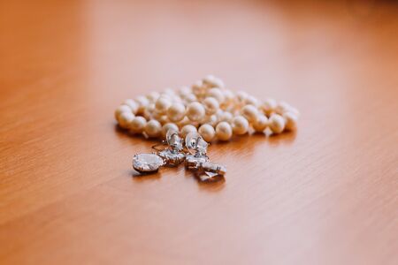 Precious cute pearl beads on wooden rustic background.の写真素材