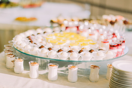 Beautifully served restaurant table with various cakes and pastries. Close-up.の写真素材