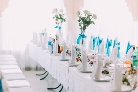 Buautifully decorated banquet table setting with different food and flowers.の写真素材