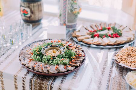 Table of different tasty snacks, served in traditional east slavic rurral style, close-up.の写真素材