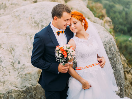 Beautiful wedding couple on wonderful rocky landscape of Carpathians mountains background close upの写真素材