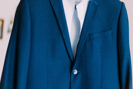 Close-up of expensious blue suit hanging indoors.の写真素材