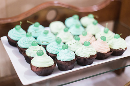 Rows of delicious cupcakes on a stand at catering party.の写真素材