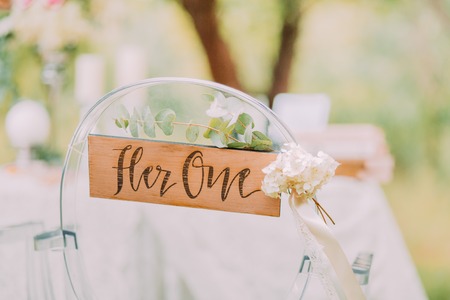 Modern chairs and table with flower composition prepared for married couple in forest.の写真素材