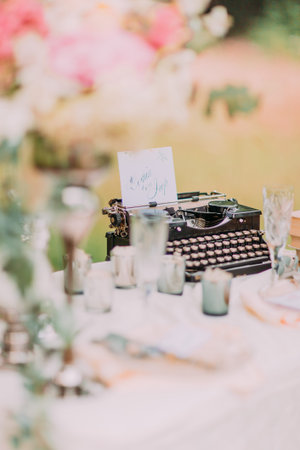 Hipster and Retro Still Life. Vintage black typewriter standing as wedding decorations.の写真素材
