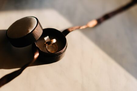 Golden wedding rings put in brown boxの写真素材