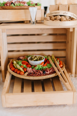Salted vegetables and meet stand on the wooden plateの写真素材