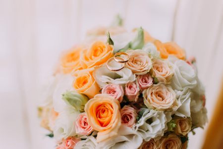 Close up of elegant bridal bouquet on the table near windowの写真素材