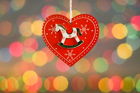 Christmas decorations. New Year red heart with cute hourse on itの写真素材