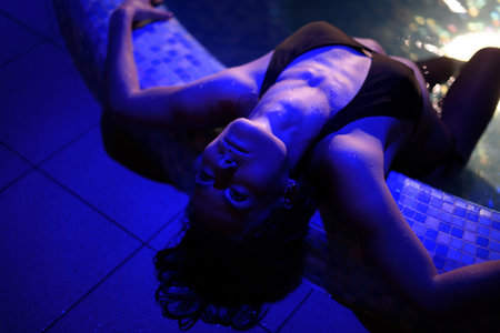 close up side photo of Beautiful girl in spa. Attractive curves in amazing light