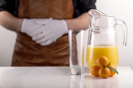 Jar of orange juice. Chef and fruits are near. Healthy lifestyle conceptの写真素材