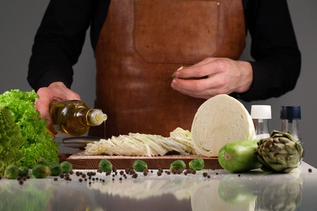 Healthy vegetable with oil dressing. Pouring oil. Healthy vegetarian food. Vegan. Diet, dieting concept.の写真素材