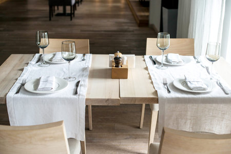Dinner table in a restaurant or cafe serving with kitchen utensils.
