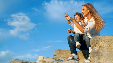 Mother and son looking at something in the sky.の写真素材